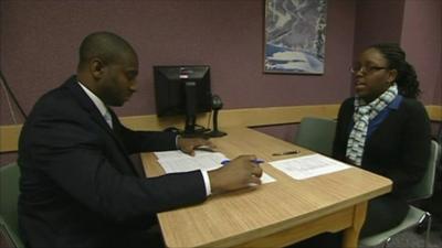 An unemployed lady receives CV tips at a career centre