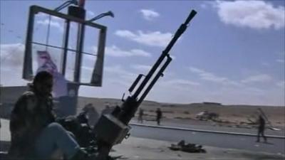 An armed vehicle beside a highway in Libya