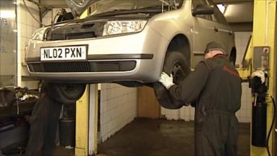 Mechanics working on a car