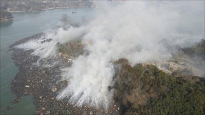 Smoke rises after earthquake and tsunami hit Kesennuma City