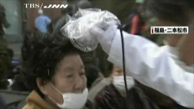 A Japanese woman is tested for signs of radiation