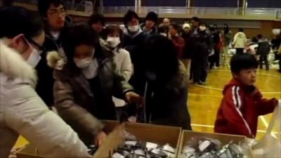 People collecting food at Fukushima High School