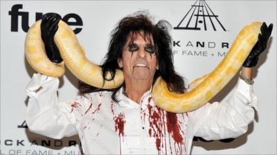 Alice Cooper poses with a snake