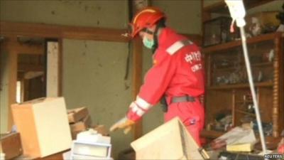 Rescue worker searches the wreckage