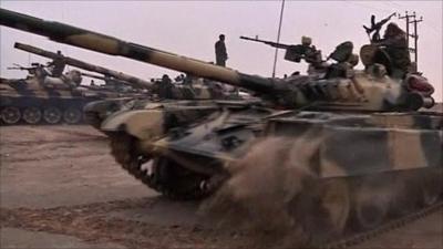 Pro Gaddafi tanks and fighters moving through the desert