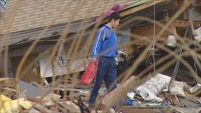 Man walking through rubble in Kamaishi, Japan