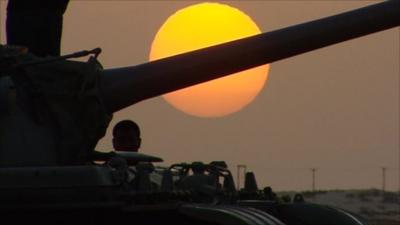 Tank with sunset behind it