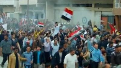 Demonstrators march through Syrian city of Daraa