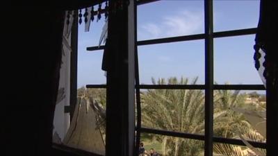 Window with broken glass in Tripoli