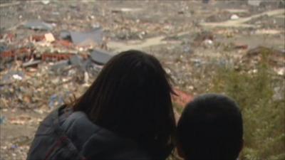 Rikuzentakata residents look at wreckage