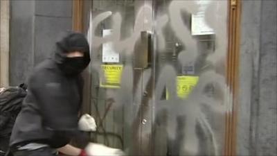 Protester sprays 'class war' on office door