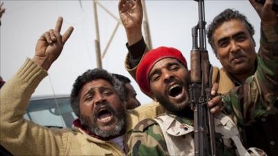 Libyan rebels jubilate on a checkpoint in Al-Egila