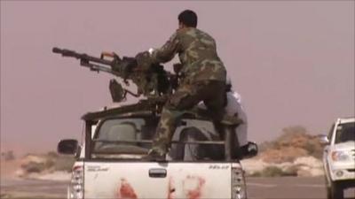 A man on vehicle with a gun