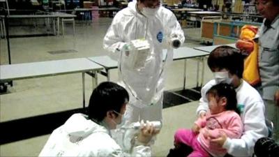 Japanese child checked for radiation level by medical workers