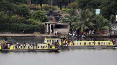 Youth supporters of Ivory Coasts President Laurent Gbagbo take a boat to the presidential palace in Abidjan