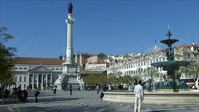 People near a fountain in Portugal