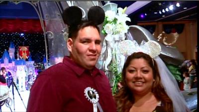 American couple in his and hers Disney mouse ears