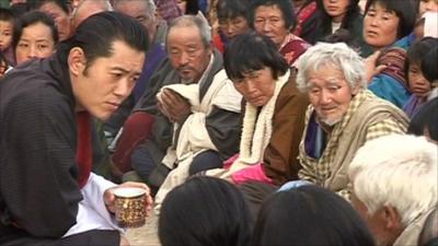 The King of Bhutan listening to a group of people