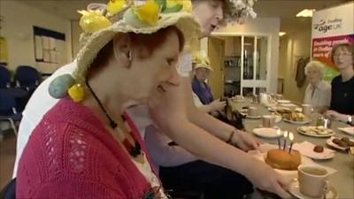 Woman presented with birthday cake