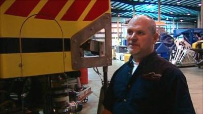 Tim Weller next to one of Phoenix International's deep-sea salvage vessels