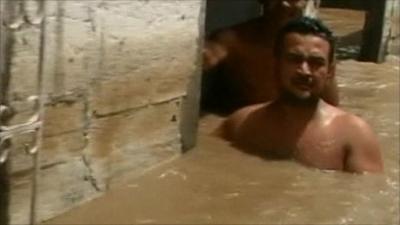 Man up to his chest in floodwater