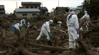 Workers clearing rubble in Japan