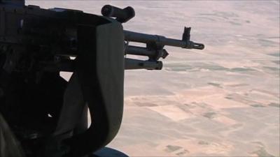 Rifle aimed out of helicopter