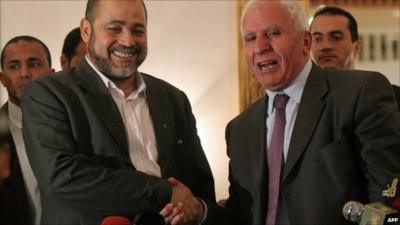 Fatah chief Azzam al-Ahmed (r) shakes hands with Hamas deputy leader Mussa Abu Marzuq