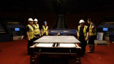 Workers take down the second table at the Crucible before the World Championship semi-finals begin on Thursday.