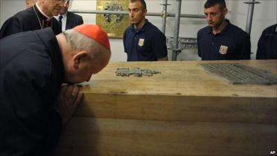 Cardinal Stanislaw Dziwisz kisses the coffin of Pope John Paul II