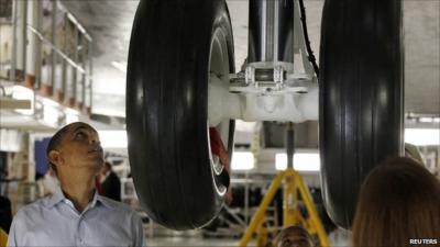 President Barack Obama next to the undercarriage of the Atlantis shuttle