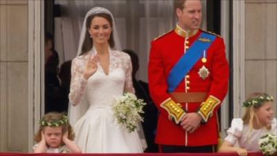 Bridesmaid covers her ears as she stands next to Kate Middleton and Prince William