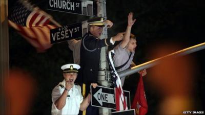 People climb lamp post in celebration