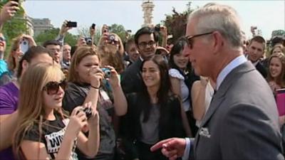 Students taking photos of Prince Charles