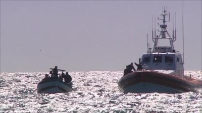 Boats hold migrants on sea