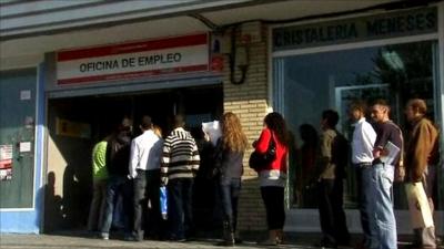 Spanish people queue outside employment office