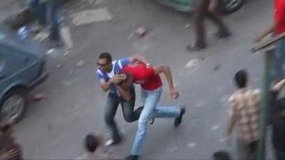 Two men run through Cairo