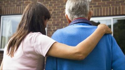 Elderly man and carer