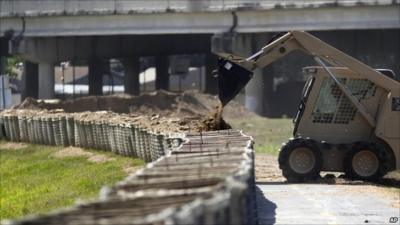 A digger building up levee