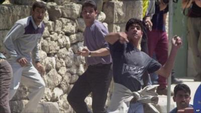 Ramallah protester throws stone