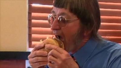 Don Gorske tucks in to his 25,000th burger