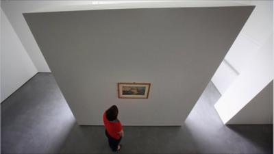 A gallery assistant views JMW Turner"s Wakefield Bridge (circa 1798) in the new Hepworth Wakefield Gallery