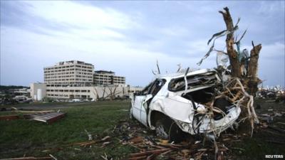 Mangled car rests against a tree near St. John"s Regional Medical Center, Joplin