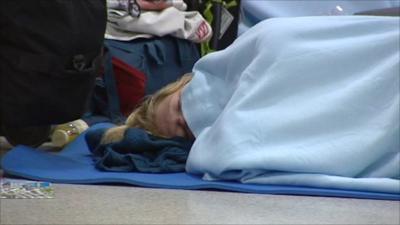 Woman sleeping on Edinburgh airport floor