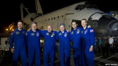 The crew stand in front of shuttle Endeavour