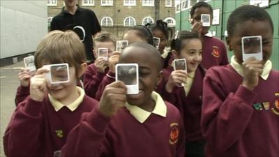 Children holding up magnifying glasses