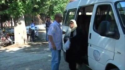 Refugees get off mini bus in Turkey