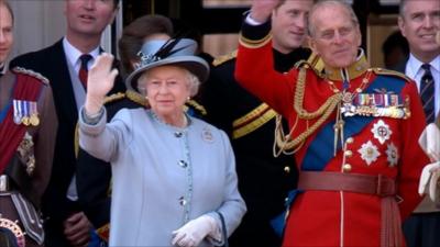 The Queen and Duke of Edinburgh wave to crowds