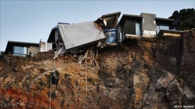 Remains of damaged house on a cliff which fell away during the quake