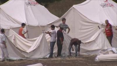 Syrians building new refugee tents in a Turkish camp